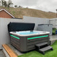 CX-6 Hot tub installed in a garden with lighting