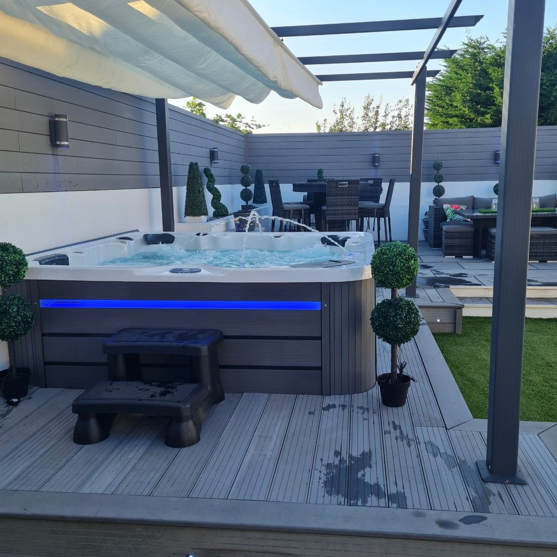 CX-6 Hot tub installed in decking with lighting and a pergola over the top